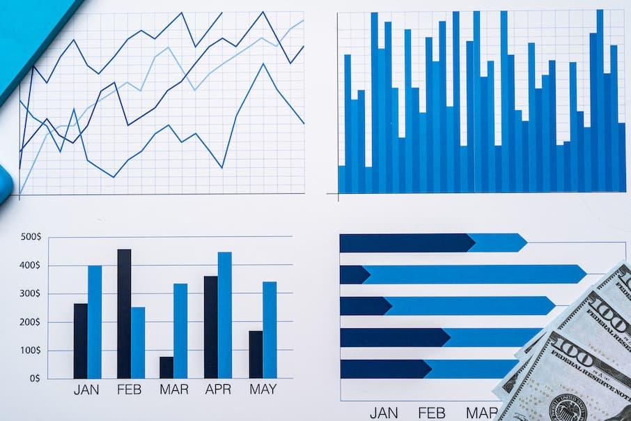 Financial Paper With NOI Charts And Diagrams On Gray Table Top View