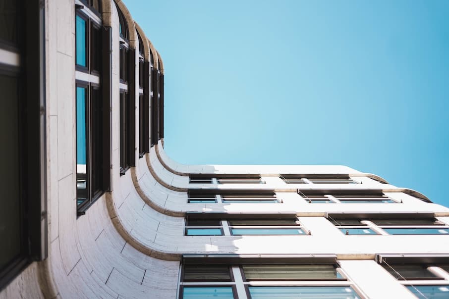 A Low Angle Shot Of A Modern Building With Large Glass Windows